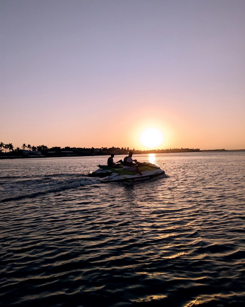 Sunset view of two jet skis in the ocean on Marco Island